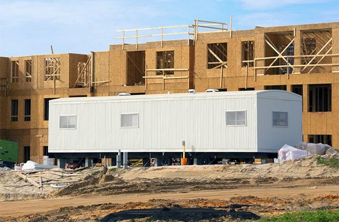 workers studying blueprints in a temporary rental office in Hauppauge, NY